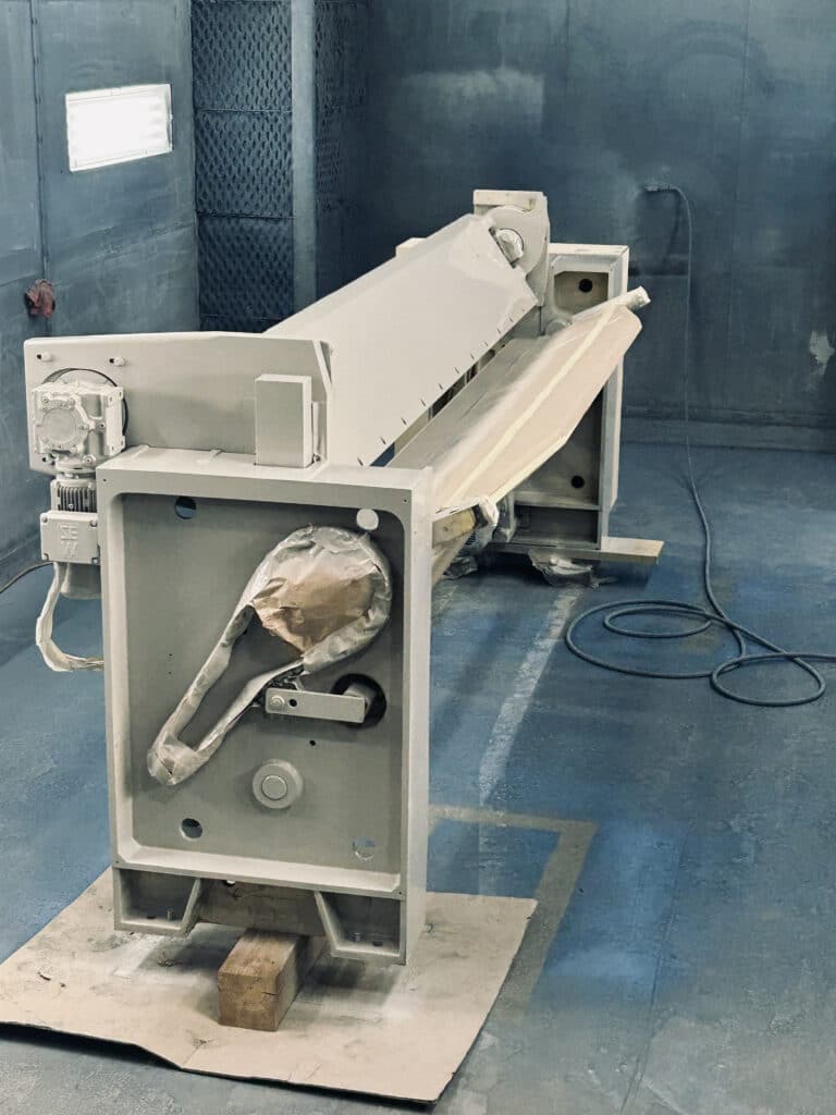 Metal fabrication equipment in paint room.